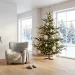 Wide horizontal view of a serene Nordic Christmas living room with white decor and minimalist pine tree.