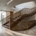 Wide shot of a luxury home featuring a modern geometric laser-cut metal staircase railing and minimalist decor.
