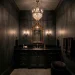 Luxurious gothic glam powder room with charcoal walls and gold mirror