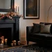Sophisticated metallic Halloween decor styling in a modern moody living room with brass skulls and mercury glass.
