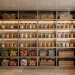 Wide view of an organized luxury stainless steel kitchen pantry with uniform storage containers.