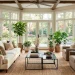 Bright 4-season sunroom with transitional decor featuring linen sofa and modern black metal accents