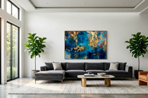 Large scale abstract art hanging above a modern sofa in a bright luxury living room interior.