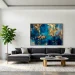 Large scale abstract art hanging above a modern sofa in a bright luxury living room interior.