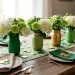 Wide horizontal view of St. Patrick's Day mason jar vases on a farmhouse table with gold accents.