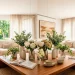 Beautiful faux floral arrangements on a wooden coffee table in a bright, modern living room banner.