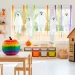 Bright and colorful DIY Halloween decorations in a modern sunlit kids playroom with rainbow pumpkins.