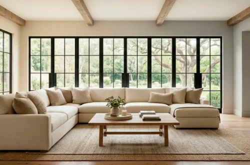 Cozy modern farmhouse living room with layered cream and beige textures and natural wood accents.