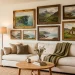 Cozy scandinavian living room gallery wall featuring various framed vintage Irish landscape oil paintings above a linen sofa.