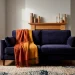 Cozy living room interior featuring deep indigo velvet furniture and elegant dramatic fall room decor accents.