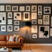 Wide horizontal view of a sophisticated living room with a long modular gallery wall and leather sofa.