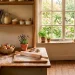 Wide landscape view of a functional cottagecore kitchen nook with vintage baking tools and warm sunlight.