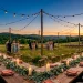Sophisticated outdoor wedding reception at sunset with a harmonious terracotta and green color scheme.