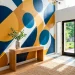 Modern entryway featuring a bold geometric wall mural in navy, mustard, and white