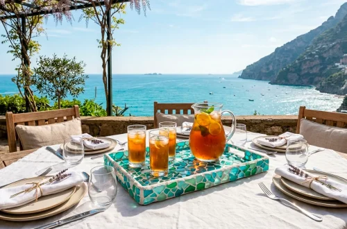 Beautifully set outdoor summer table featuring a sea glass mosaic tray centerpiece