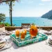 Beautifully set outdoor summer table featuring a sea glass mosaic tray centerpiece
