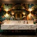 Luxurious moody powder room interior featuring bold botanical wallpaper and brushed brass fixtures