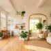 Wide view of a bright studio apartment using a large arched floor mirror to reflect a window and double the visual space