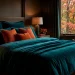 Luxurious deep teal bedding in a moody autumn bedroom setup with warm ambient lighting and burnt orange accents.