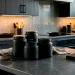Collection of stylish matte black kitchen canisters sitting on an edgy modern countertop
