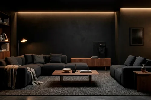 Moody Scandi-Noir living room featuring a dark charcoal sofa, matte black walls, and walnut accents.