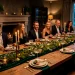 Sophisticated St Patrick's Day dinner table setting with emerald green runner, brass candelabras, and crystal glassware.