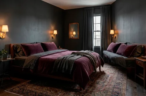 Sophisticated moody guest bedroom with charcoal walls and deep plum velvet bedding