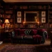 Sophisticated dark academia living room with burgundy velvet pillows and burning taper candles for Valentine's Day