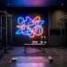 Dark moody home gym illuminated by a bright vibrant abstract neon light installation above heavy weights.