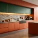Stunning modern 2025 kitchen interior featuring deep green cabinets, marble backsplash, and warm brass accents.