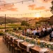 Rustic reclaimed wood wedding decor welcome sign set up at an outdoor sunset reception