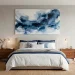 Large calming blue abstract painting above a comfortable bed in a bright modern bedroom