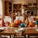 Beautifully styled Thanksgiving dining table featuring elaborate 3D paper pumpkins and paper autumn leaf garlands.