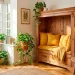 Wide view of a cozy reading nook created from an upcycled antique dresser with mustard yellow cushions