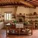 Warm Mediterranean kitchen featuring rustic terracotta tile floors and wood beams.