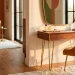 Wide view of a realistic mid-century modern dressing room featuring a walnut vanity and geometric decor.