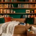 Wide view of a cozy reading nook transformed from an unused closet with green walls and floating bookshelves