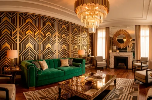 Luxurious Art Deco living room with emerald velvet sofa, gold geometric panels, and crystal chandelier.