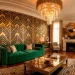 Luxurious Art Deco living room with emerald velvet sofa, gold geometric panels, and crystal chandelier.
