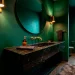 Luxurious modern powder room featuring a floating black marble vanity and emerald green walls.