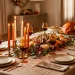 Luxurious Thanksgiving table setting featuring textured beige linen, glowing taper candles, and elegant autumn decor.
