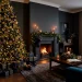 Sophisticated moody living room featuring a Christmas tree decorated with navy blue and charcoal ornaments