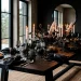 Moody Scandi-Noir Thanksgiving dining table setting with black plates and white candles
