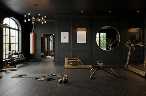 Luxurious home gym interior featuring matte black walls and sophisticated gold fitness equipment accents