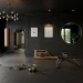 Luxurious home gym interior featuring matte black walls and sophisticated gold fitness equipment accents