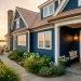 Sophisticated home exterior featuring navy blue siding and gleaming brass nautical accents during golden hour