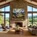 A modern living room featuring a stunning contemporary landscape painting hung above a large stone fireplace.