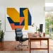 Modern home office featuring a large bold geometric abstract canvas in mustard and navy above a sleek wooden desk.