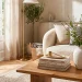 Beautifully styled modern coffee table with interior design books and a ceramic vase filled with branches