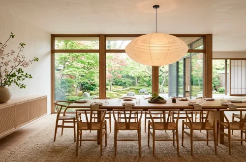 Serene Japandi style dining room featuring a light oak table, wishbone chairs, and a large paper lantern